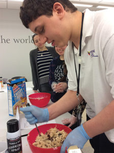 Forum School student working on cooking activities with Ramapo College students