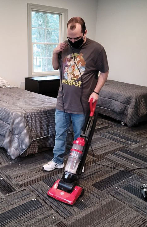 Student vacuuming in the new Life Skills Center