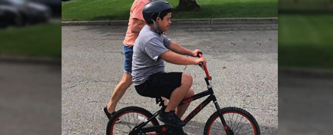 Student at The Forum School learning to ride a bike for the first time
