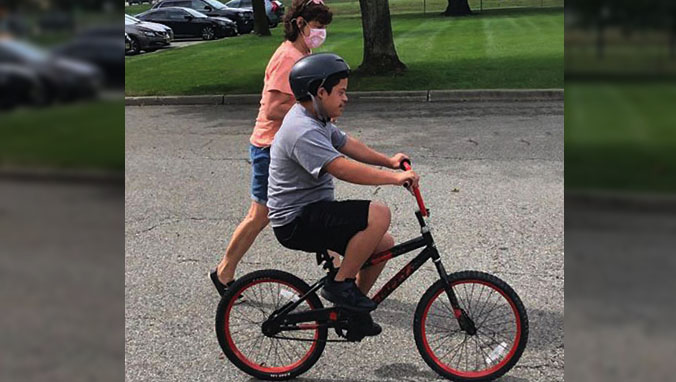 Student at The Forum School learning to ride a bike for the first time