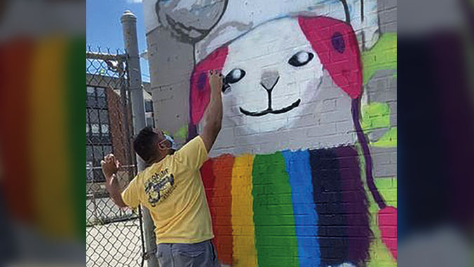 Forum student, Phoenix, painting a mural