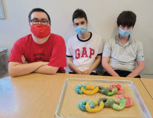 Forum students showing off their pretzels made during baking