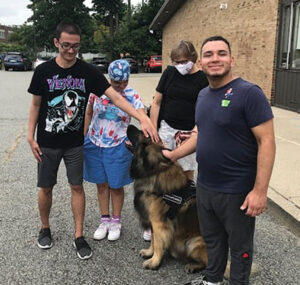 Firum students visiting with a therapy dog