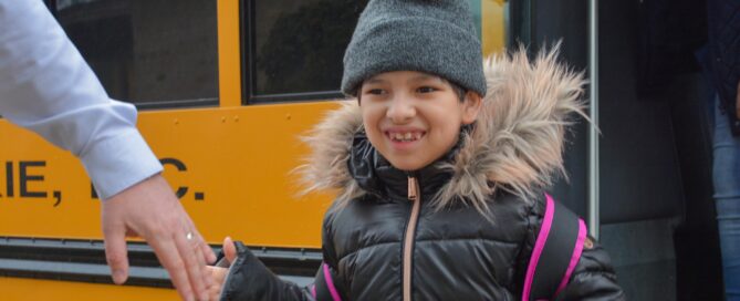 Forum student arriving at bus drop off in the morning