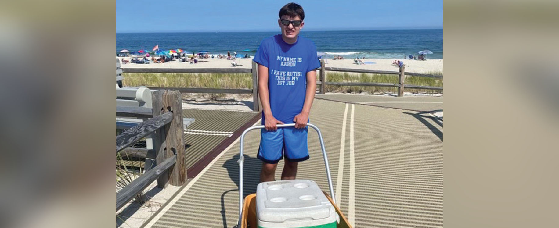 Aaron selloing ice cream on the beach while on vacation