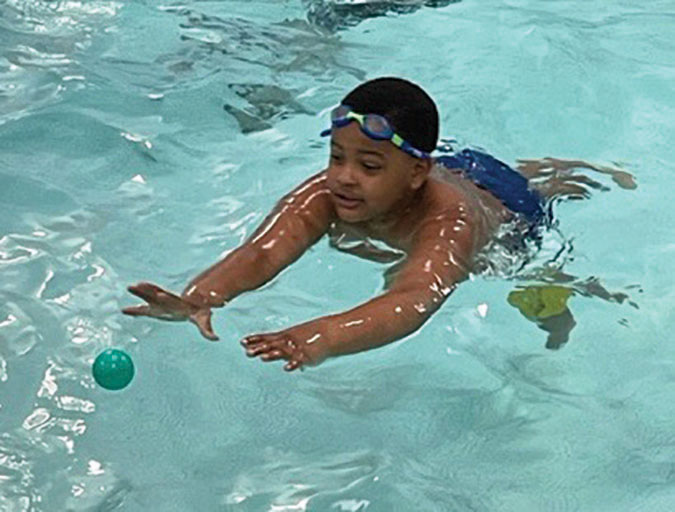Forum student enjoying exercise in the school's on campus pool.